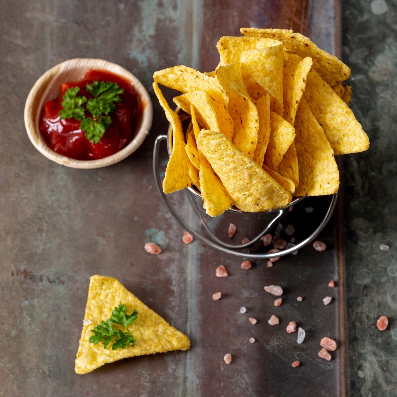 pile-nachos-bucket-tomato-sauce-bowl-with-parsley_23-2148254351